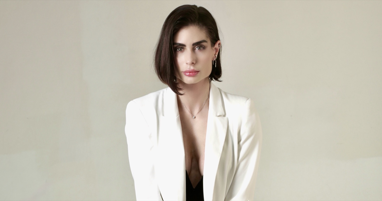 Carina in a white blazer