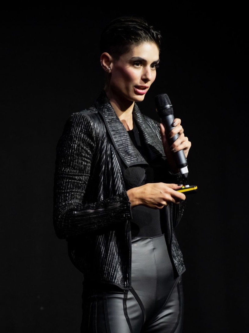 Carina on stage with a microphone at Founders Factory Demo Day
