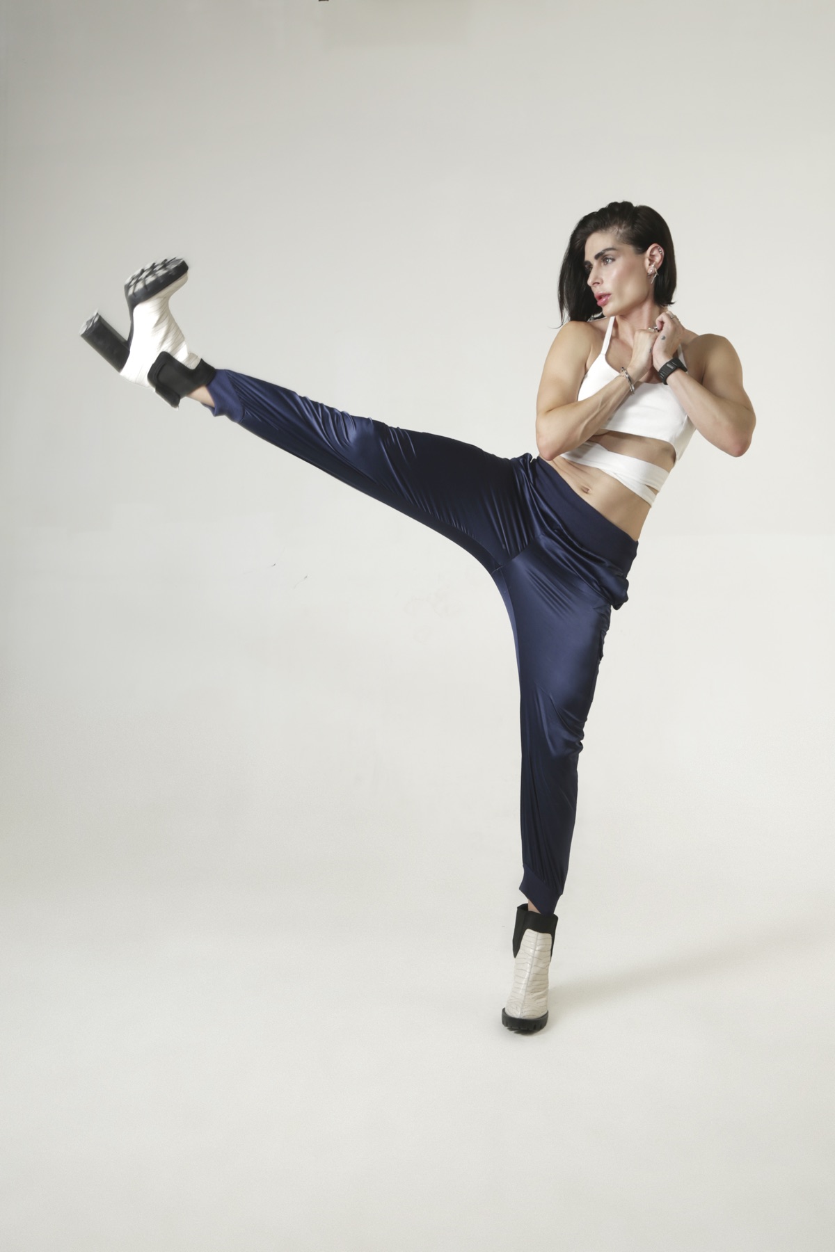 Carina mid high kick in a photo studio