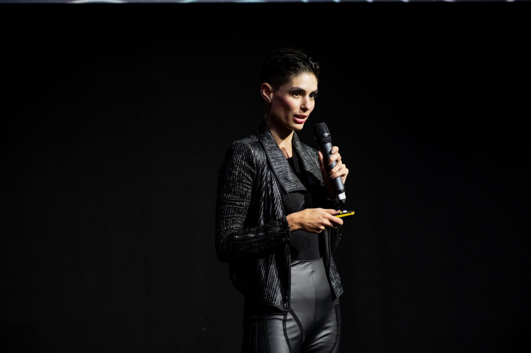 Carina on stage with a microphone at Founders Factory Demo Day